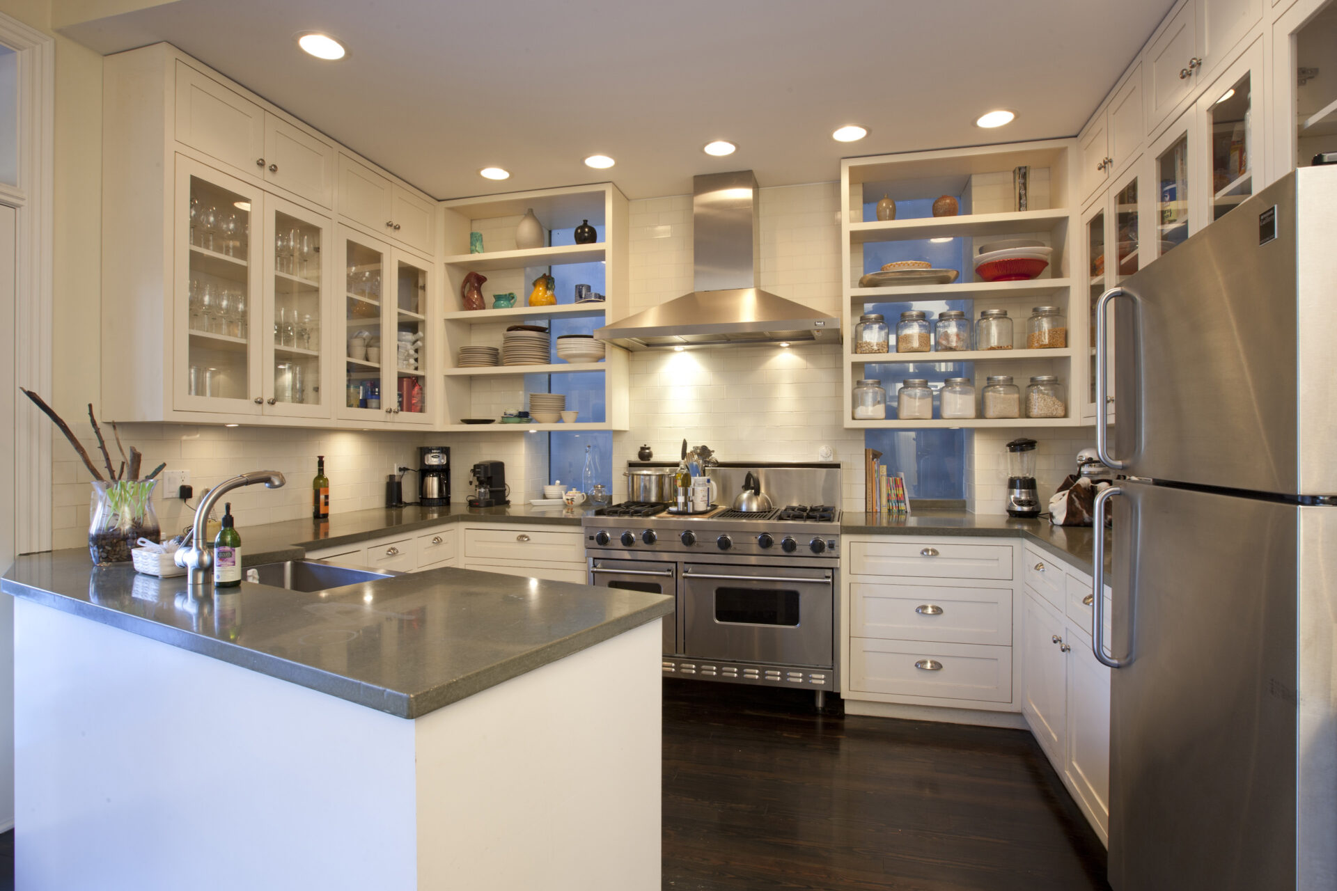 modern kitchen space with complete furniture, fixtures, appliances