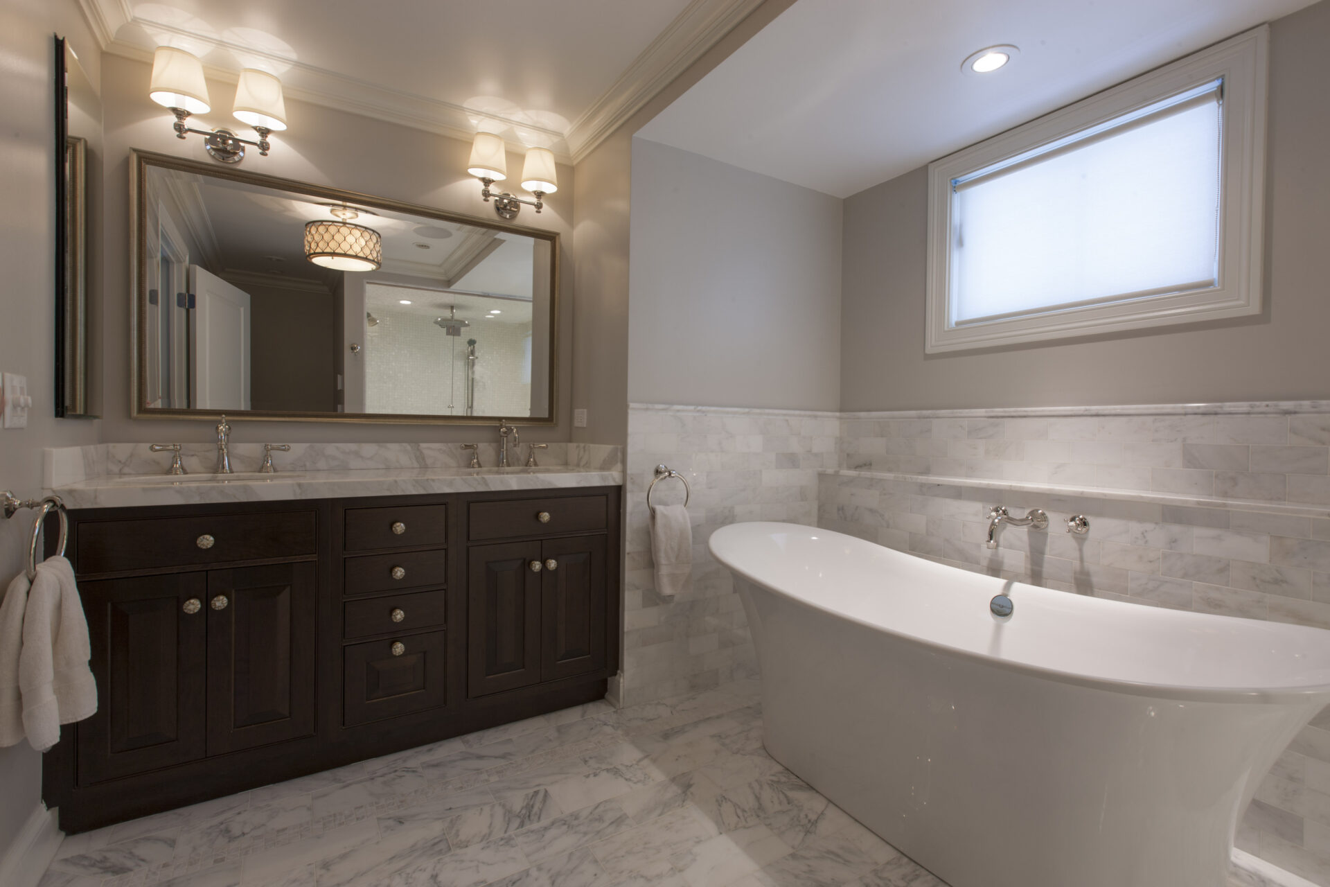 Bathroom with long mirror and tub
